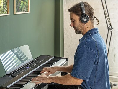 A person using headphones while playing the P-525