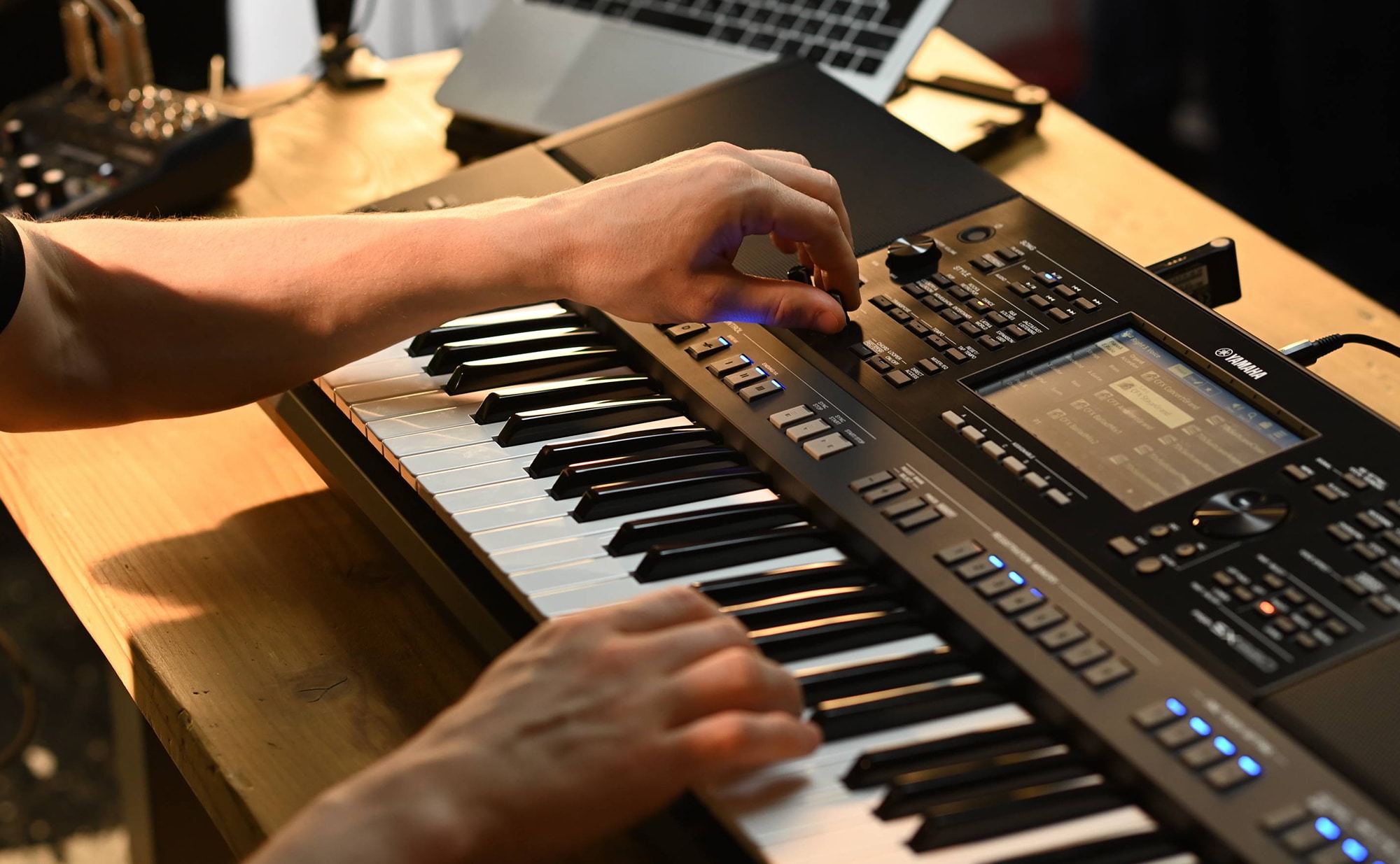 Close-up of the hand operating the Yamaha Arranger Workstation PSR-SX920.